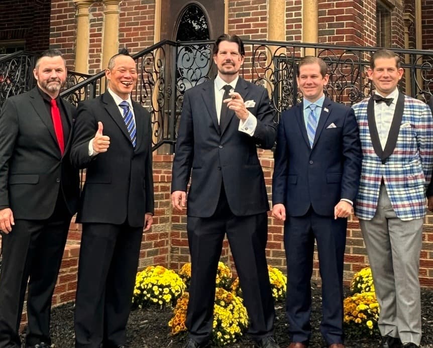 Chuck and four friends in suits outside an RMH gathering.